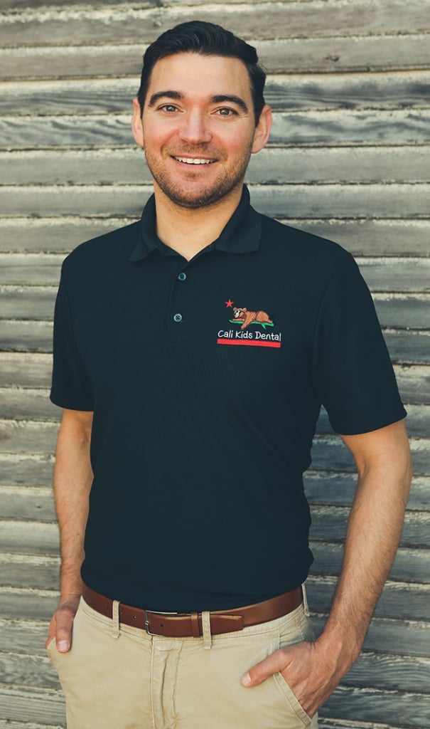 Dr. Jordan Priestley, pediatric dentist, smiling in a professional headshot.